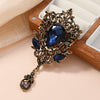 Dark blue crystal flaming heart brooch