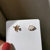 A pair of asymmetrical ear clips (plastic clips)