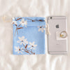 Trumpet with white flowers on blue background