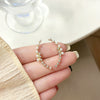 A pair of s925 silver needle stud earrings with diamonds