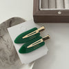 A pair of seamless duckbill clips