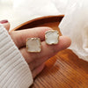A pair of s925 silver needle white stud earrings