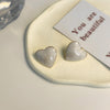 A pair of s925 silver needle white stud earrings
