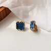 A pair of blue ear clips (anti-pain pads)