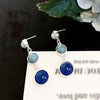 A pair of contrasting color stud earrings