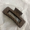 Dark brown diamond-shaped grid clip