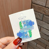 2 blue sprite bottles/card