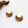 A pair of beige + brown earrings