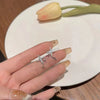 Star cross stud earrings