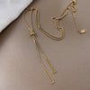 Gold triangle tassel necklace
