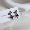 Gun black elf cat earrings