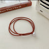 A bead [orange brown]