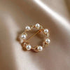 Gold hoop round pearl brooch